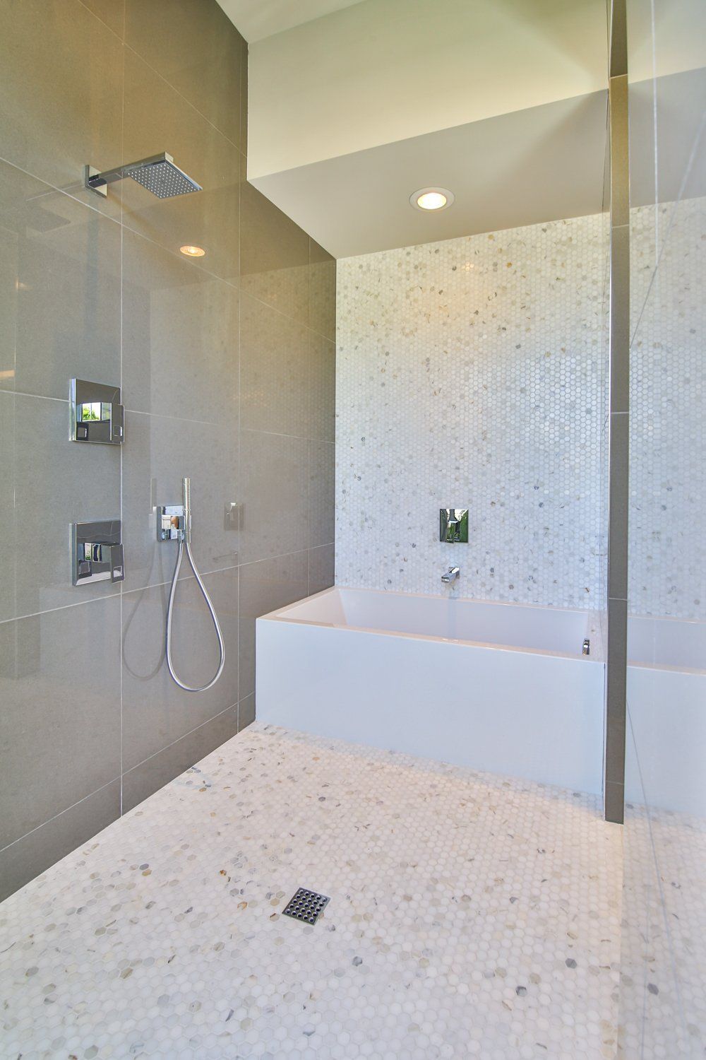 A bathroom with a bathtub and a shower.