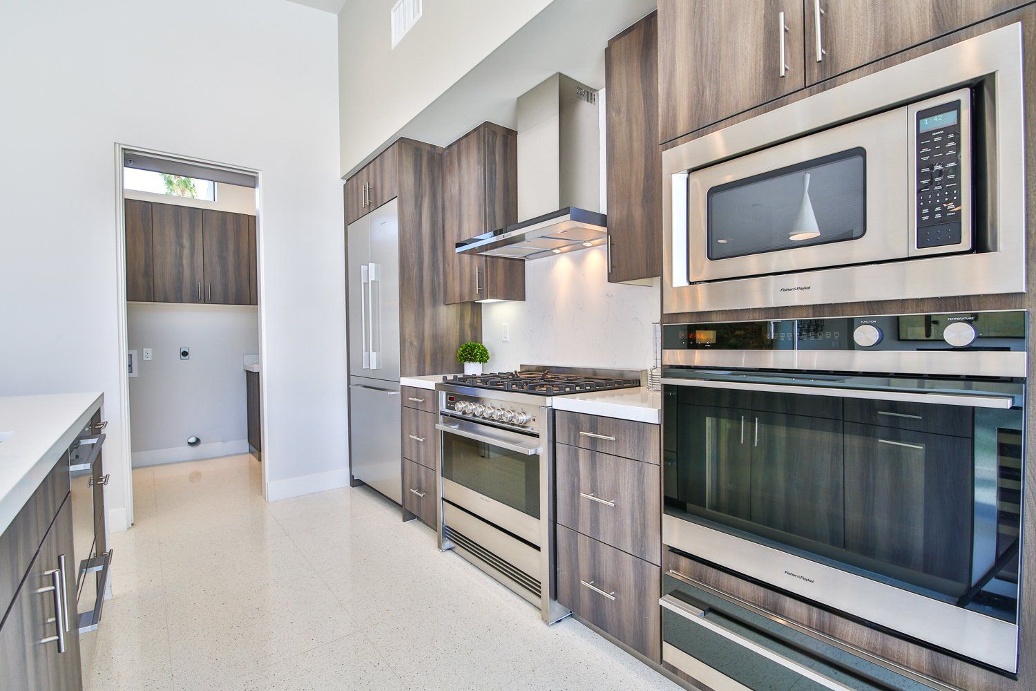 A kitchen with stainless steel appliances and wooden cabinets