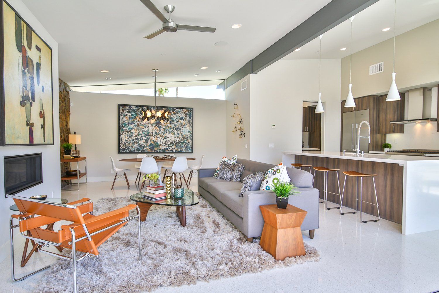 A living room filled with furniture and a ceiling fan.