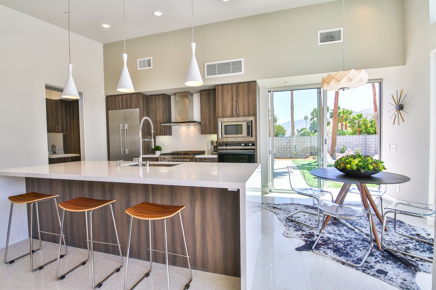 A kitchen with stools and a table in it