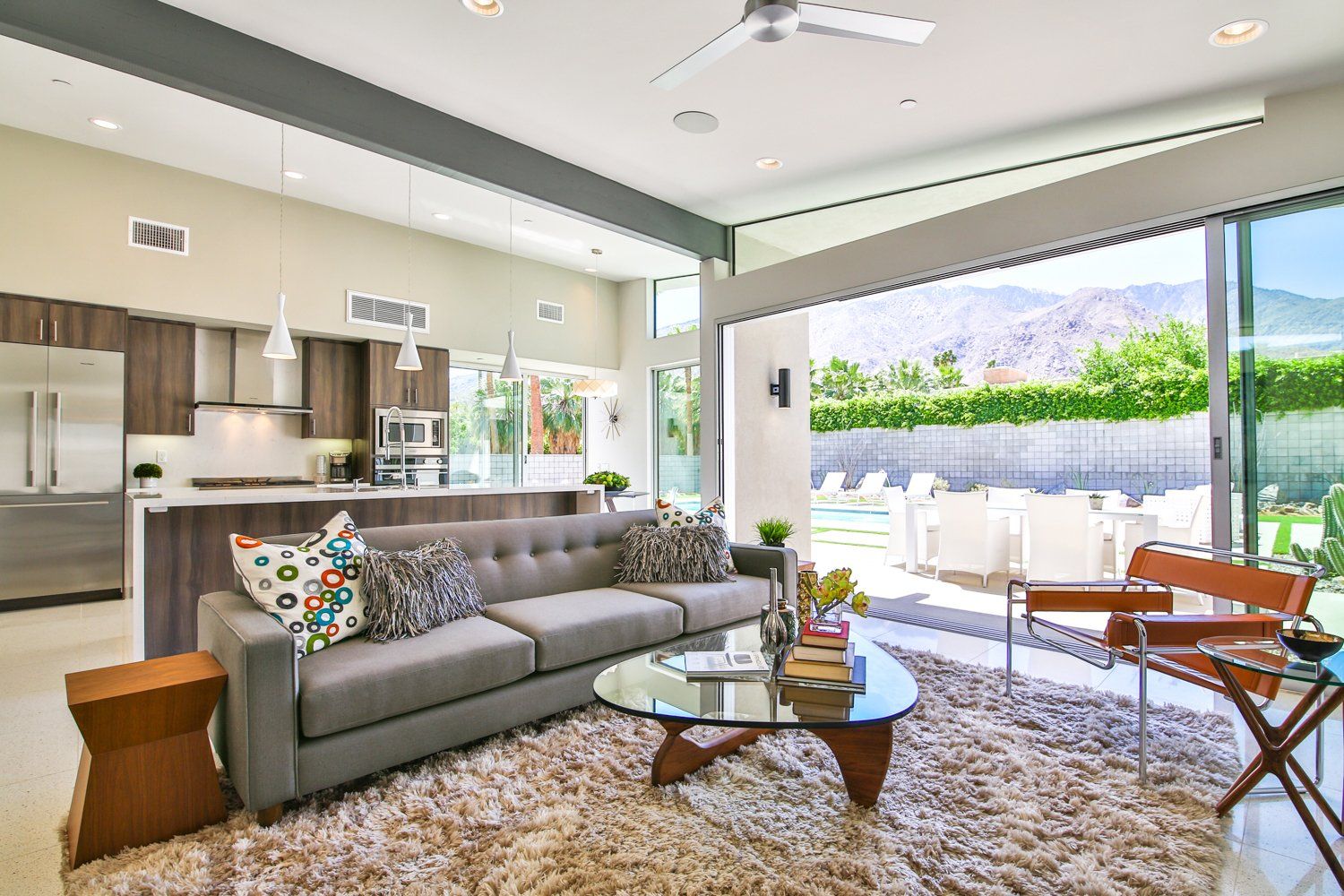 A living room with a couch , coffee table and chairs.