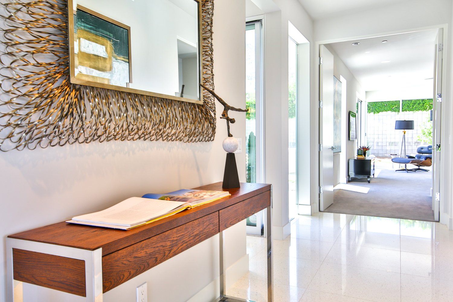 A hallway with a wooden table and a mirror