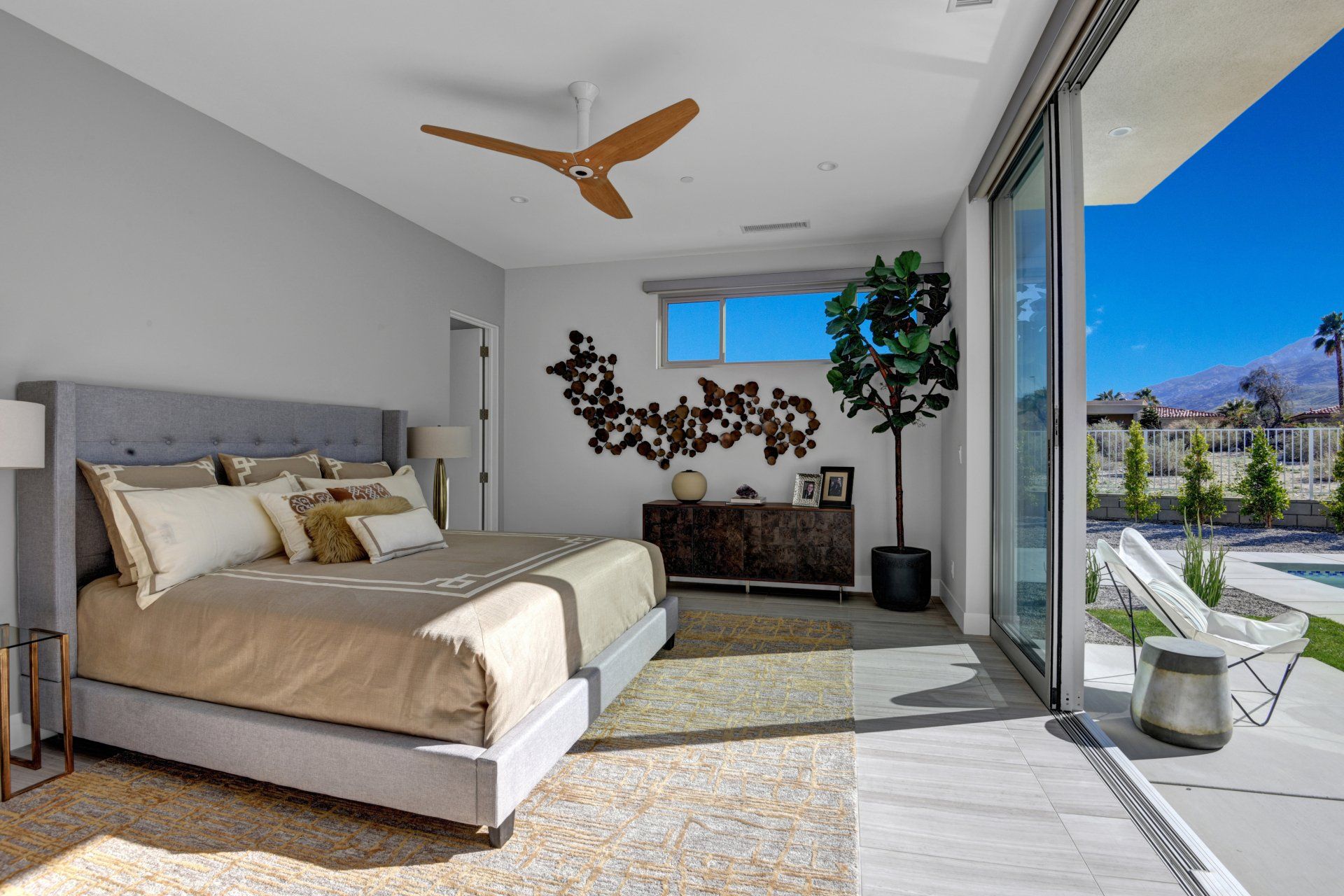 A bedroom with a large bed and a ceiling fan