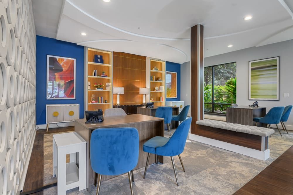 Leasing office with a wood desk and blue chairs at The 704 in South Lamar Austin, TX.