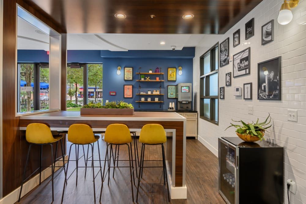 Clubhouse with a long bar table and yellow chairs at The 704 in South Lamar Austin, TX.