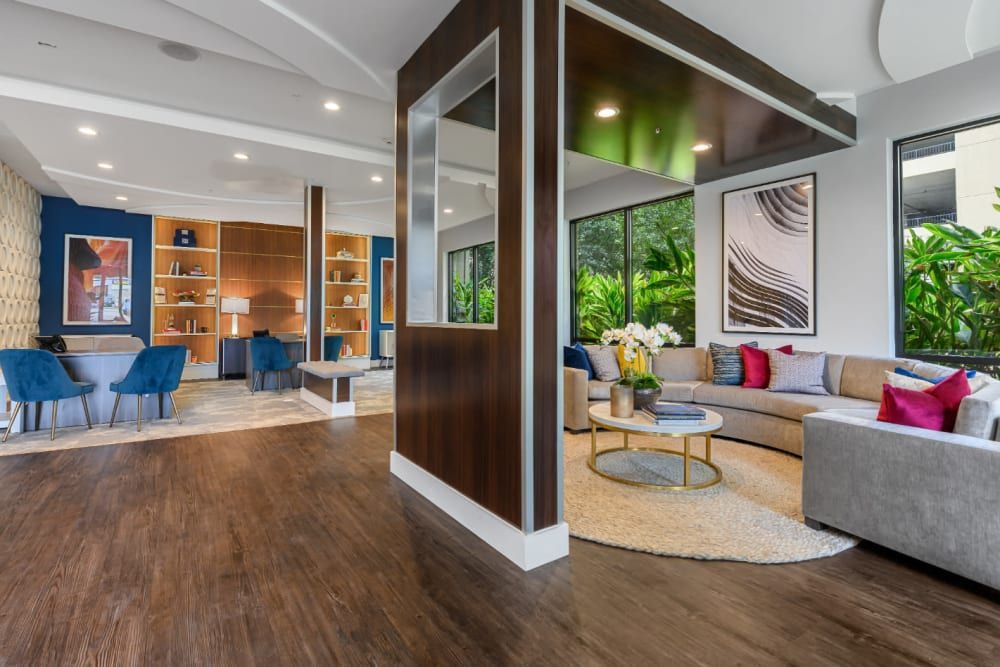 Spacious clubhouse with a couch, chairs, and a coffee table at The 704 in South Lamar Austin, TX.