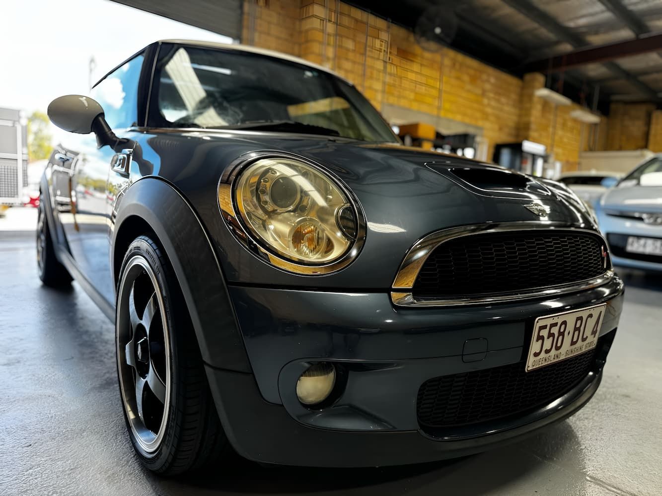 A Black Mini Cooper is Parked in a Garage — Silver Spanner Mechanics in Branyan, QLD