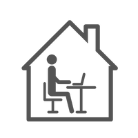 um homem está sentado em uma mesa em uma casa com um laptop.