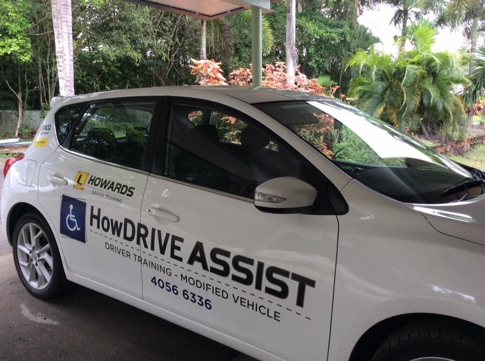 A White Howdrive Assist Car is Parked in a Parking Lot — Howards Professional Driving School In Gordonvale, QLD