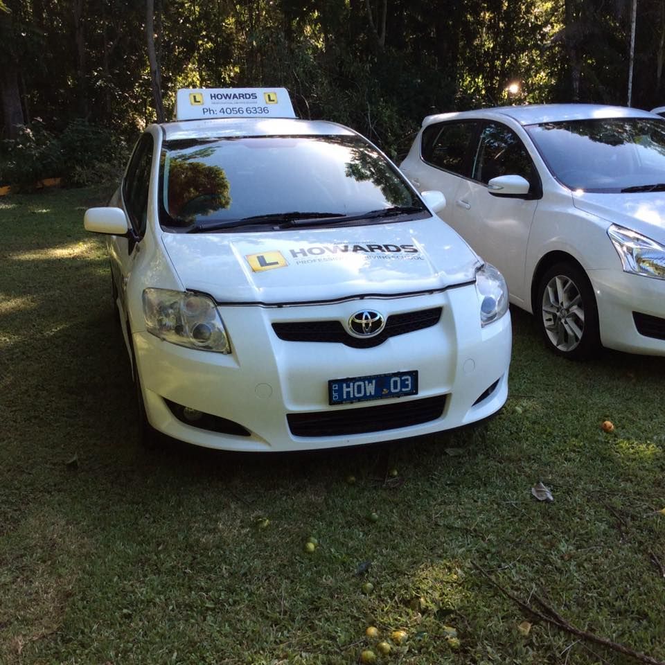 A White Car With a License Plate That Says How 03 — Howards Professional Driving School In Babinda, QLD