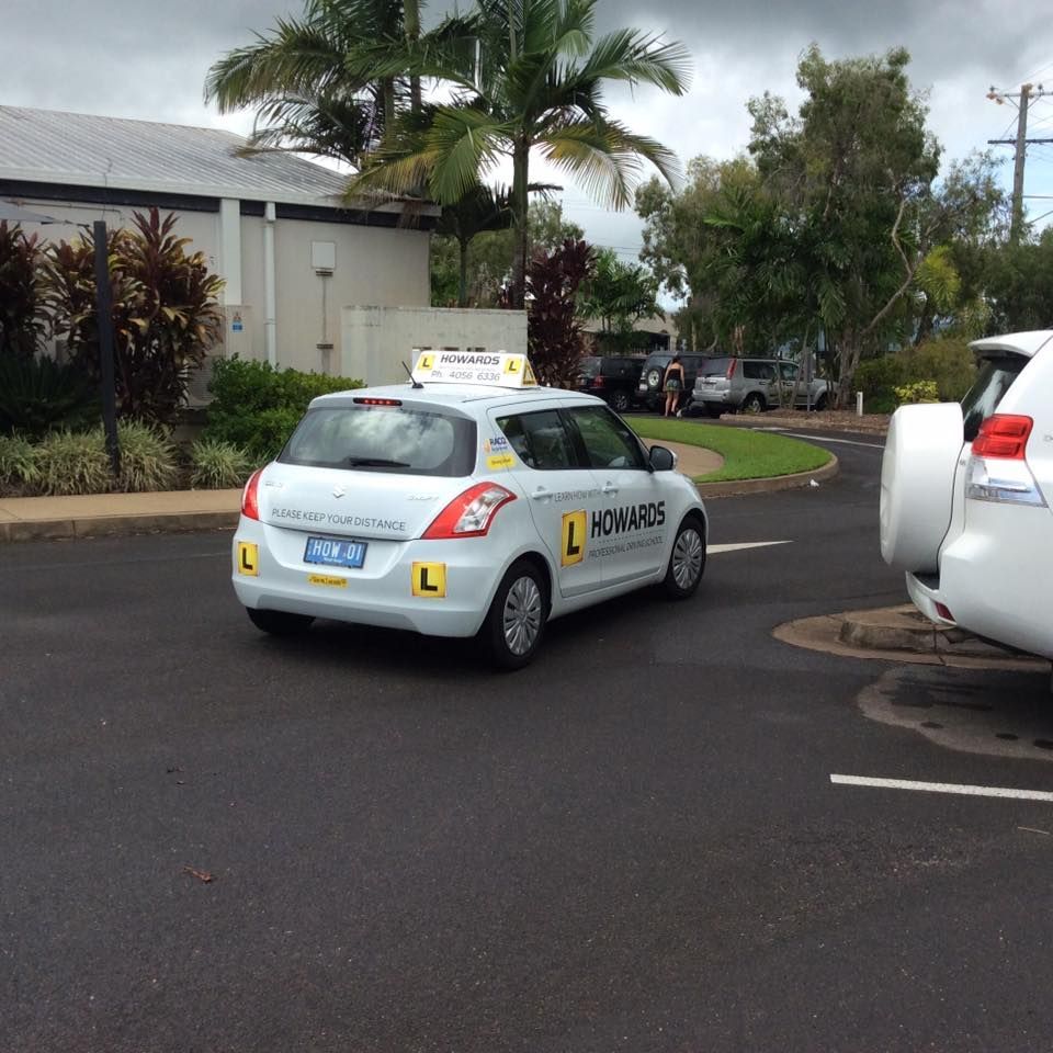 A White Car With the Letter L on It — Howards Professional Driving School In Babinda, QLD