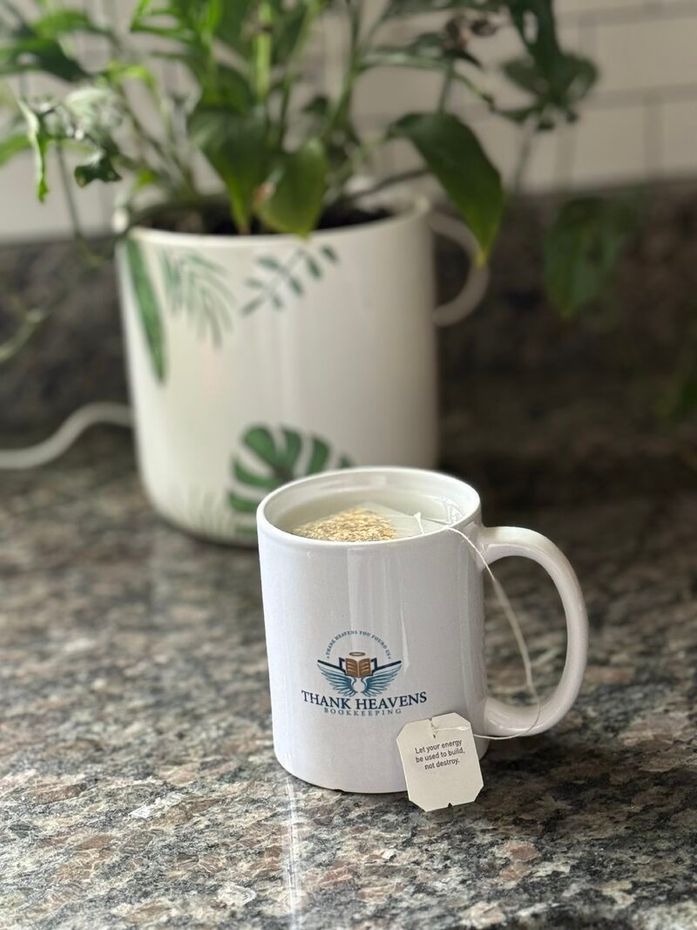 A coffee cup with a tea bag in it sitting on the counter