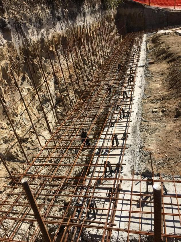 Row of Steel Bars Sitting on Top of a Dirt Field — Construction 33 in Maroochydore, QLD