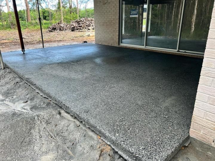 A Concrete Patio is Being Built in Front of a Brick Building — Construction 33 in Maroochydore, QLD