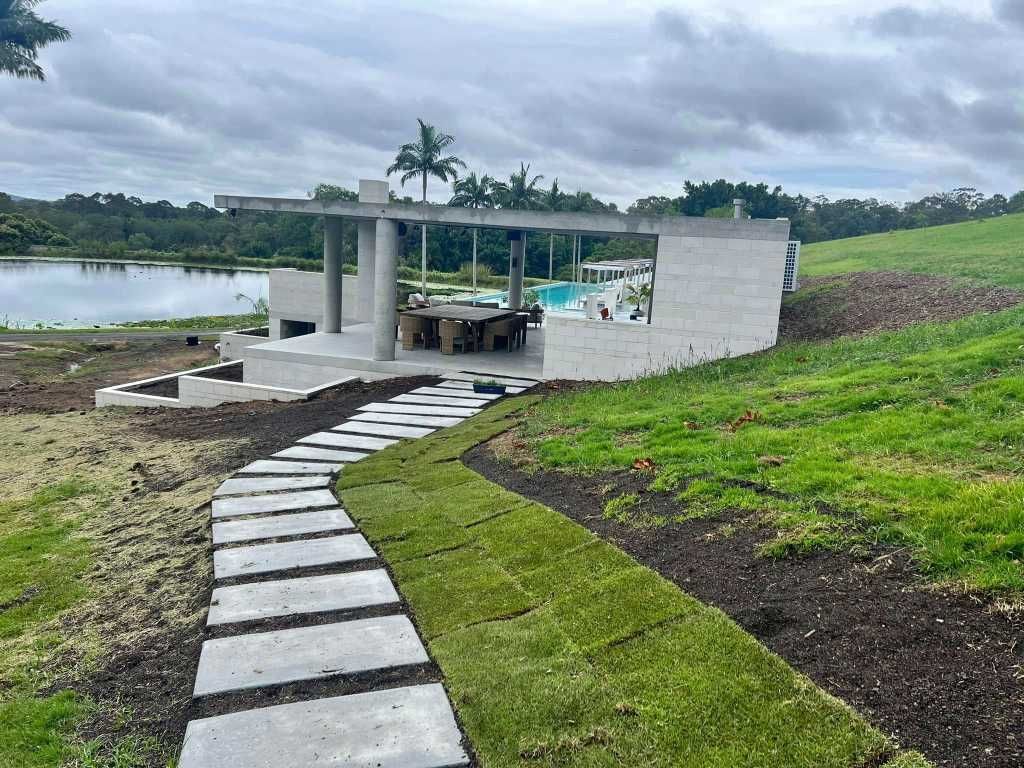 A Stone Walkway Leading to a House With a Swimming Pool in the Background — Construction 33 in Buderim, QLD