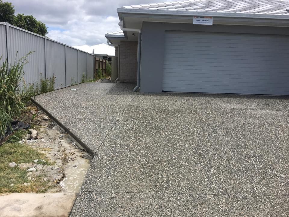 A Driveway Leading to a House With a Garage and a Fence — Construction 33 in Maroochydore, QLD