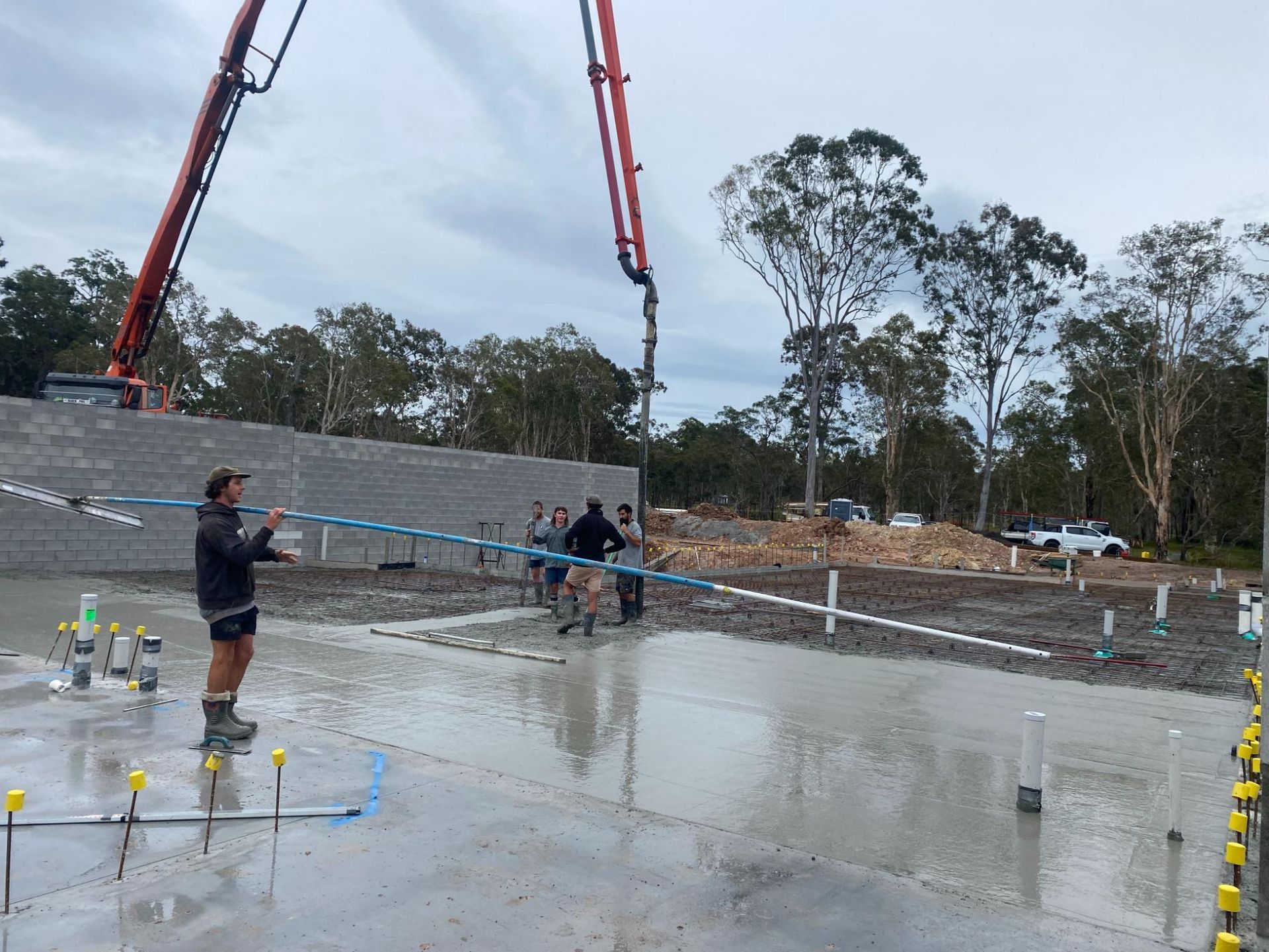 Man is Standing in Front of a Concrete Pump on a Construction Site — Construction 33 in Maroochydore, QLD