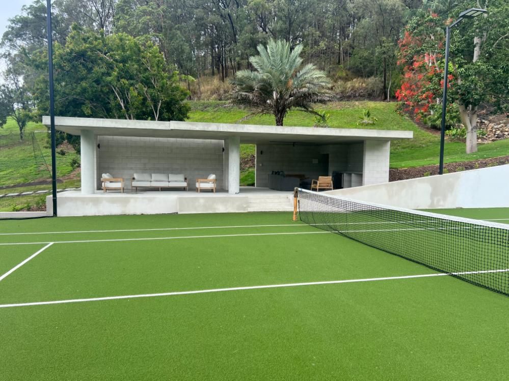 A Tennis Court With a House in the Background — Construction 33 in Sunshine Coast, QLD