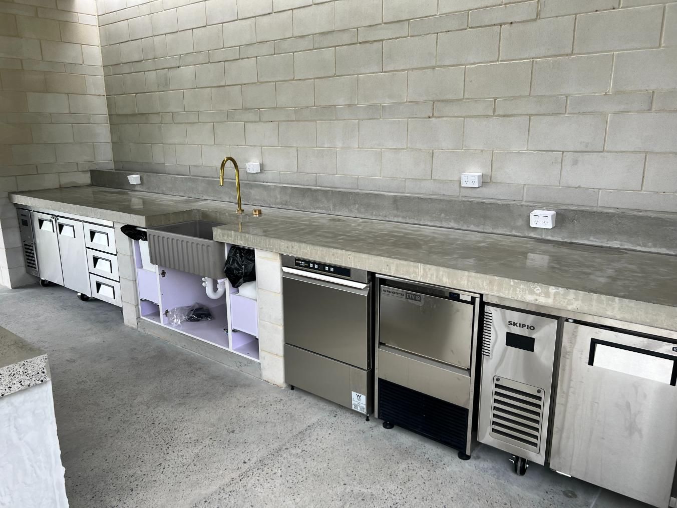 Kitchen With Stainless Steel Appliances and a Sink — Construction 33 in Caloundra, QLD