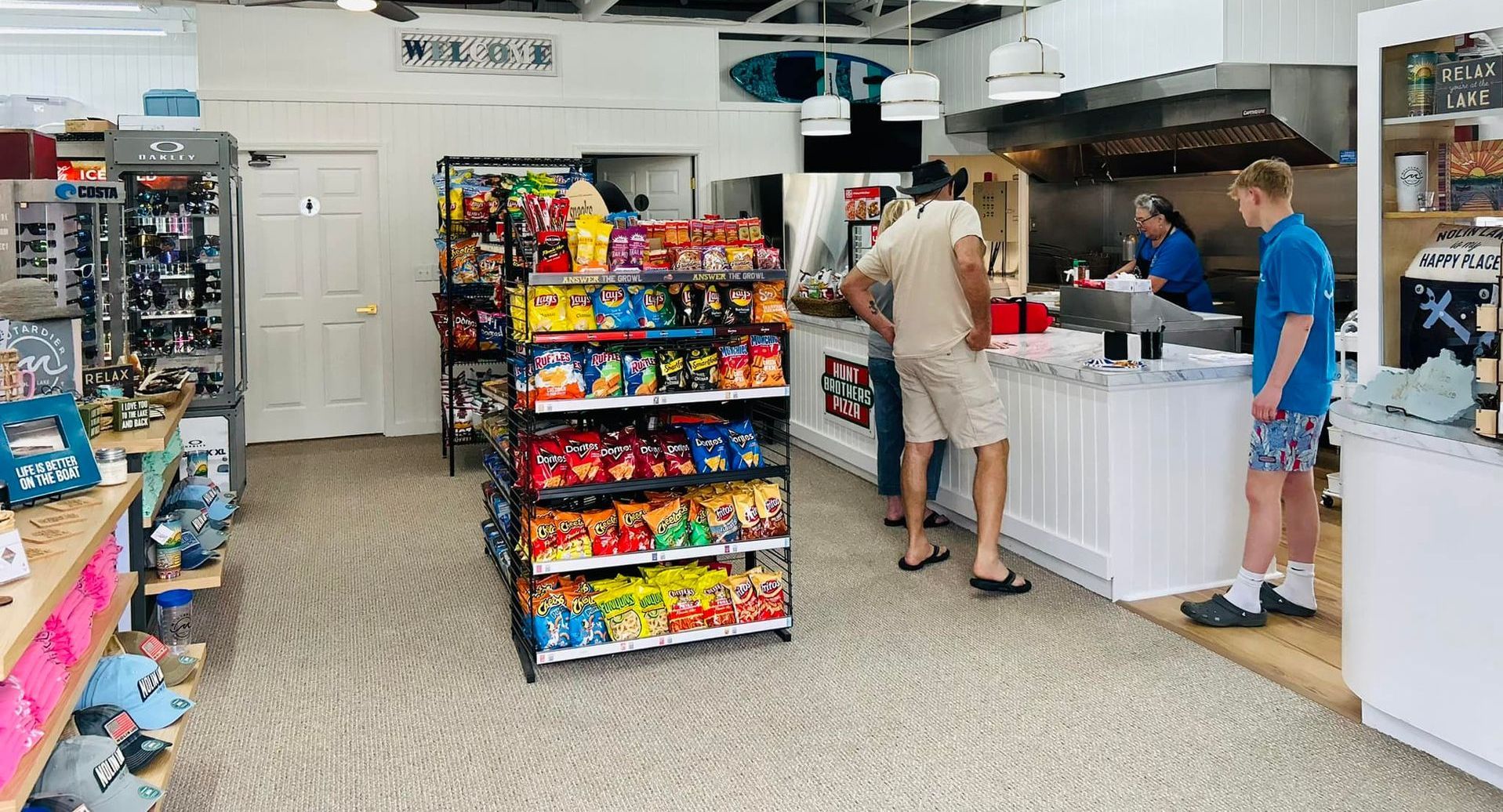 A man is standing in front of a counter in a store.