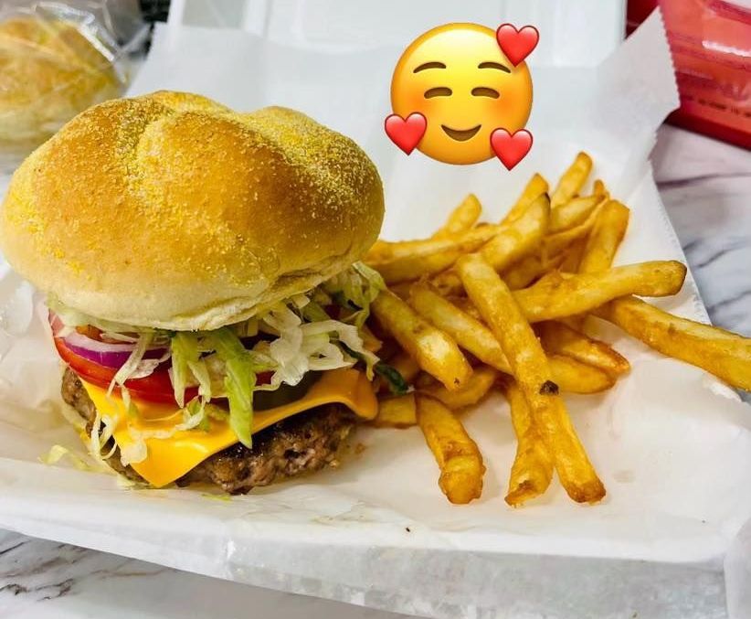 A hamburger and french fries on a styrofoam container