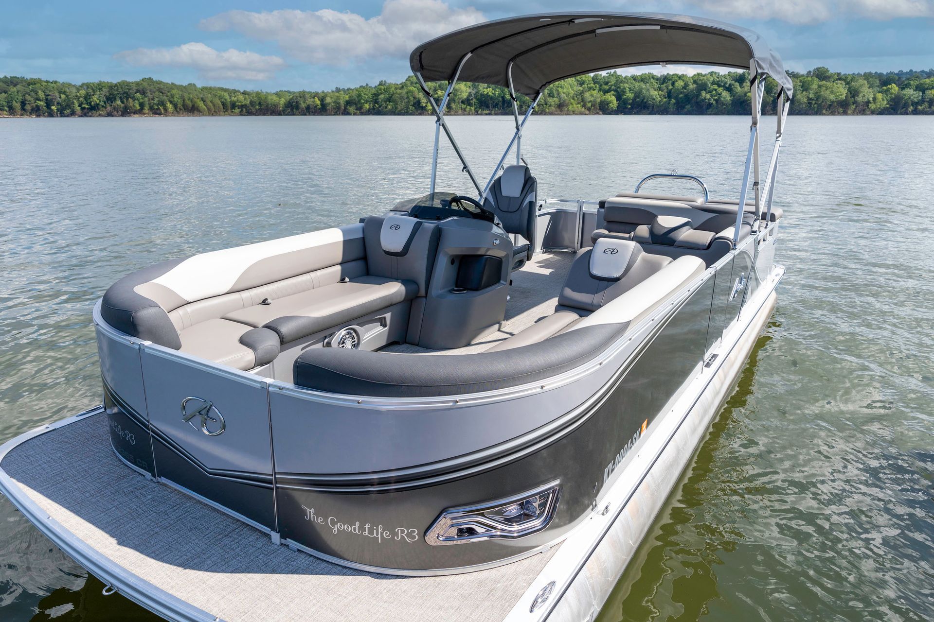 A pontoon boat is parked in front of a building.
