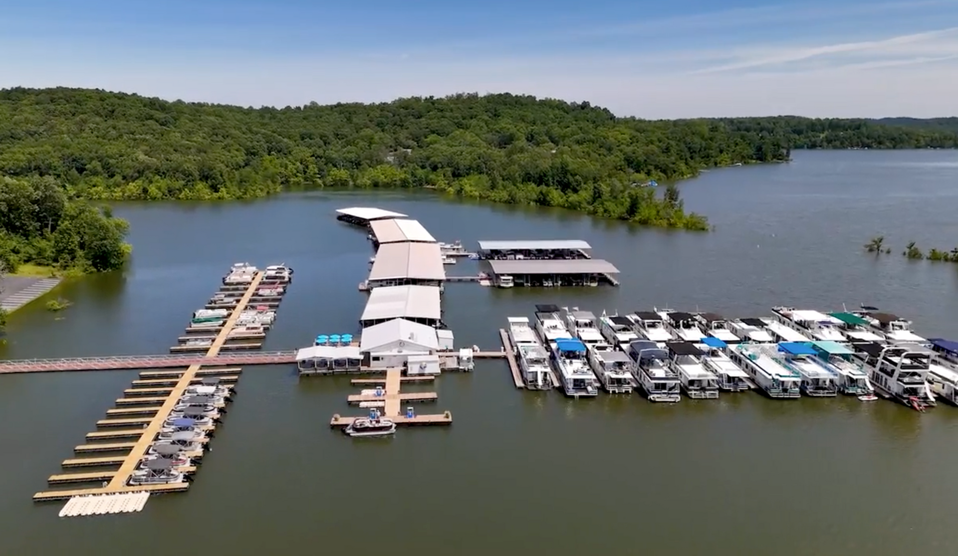 An aerial view of a marina filled with boats on a lake.