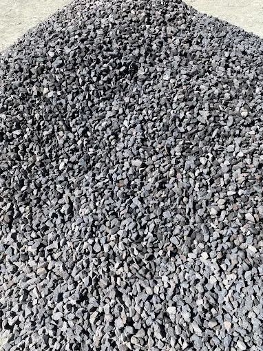 A pile of gravel is sitting on the ground.