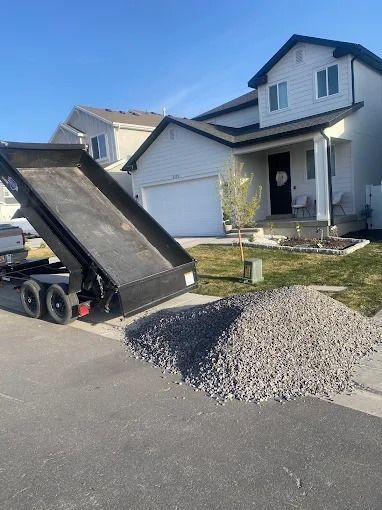 A dump truck is parked in front of a house.