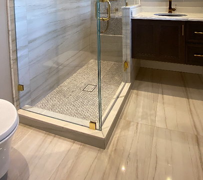 A bathroom with a walk in shower and a toilet.