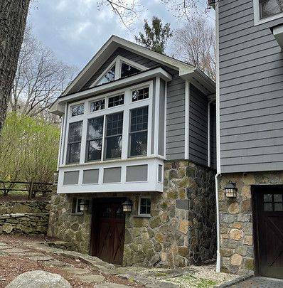 A house with a large window on the side of it
