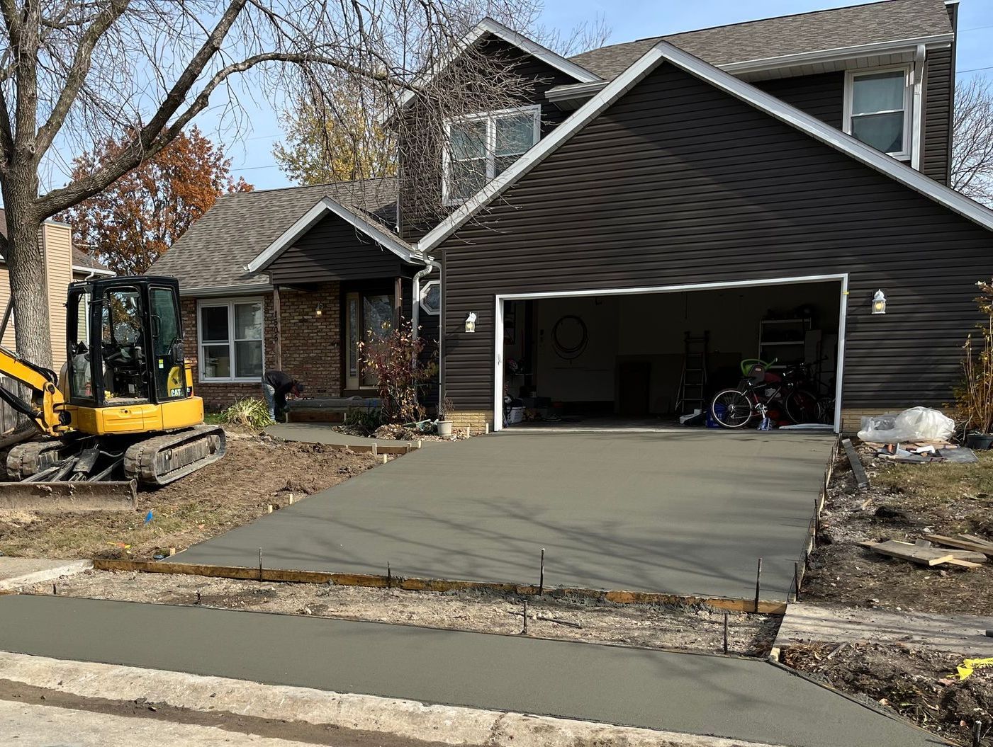 A large house with a large concrete driveway leading to it