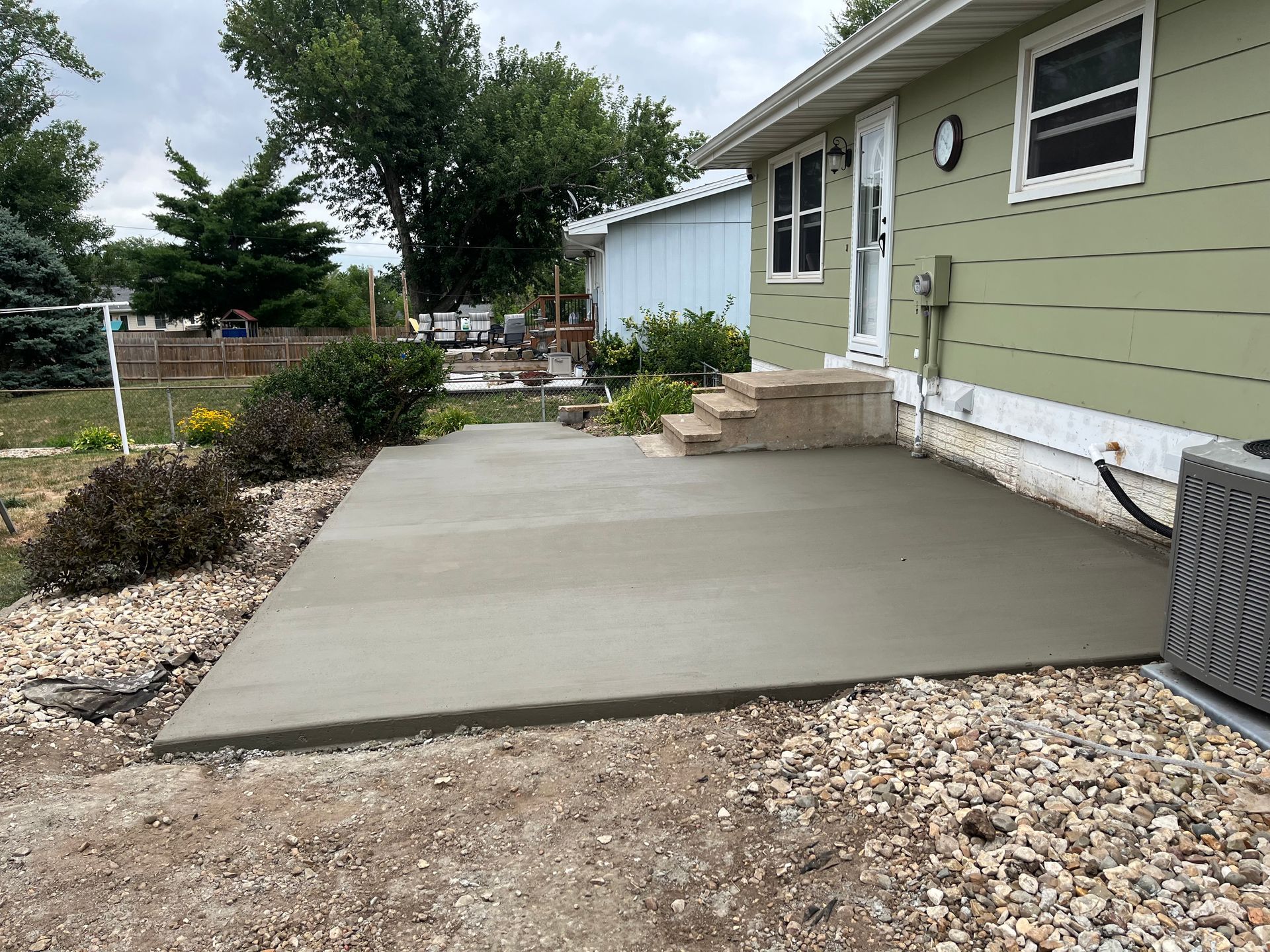 A concrete patio is being built in front of a house by Domer Concrete Solution in Marion, IA,