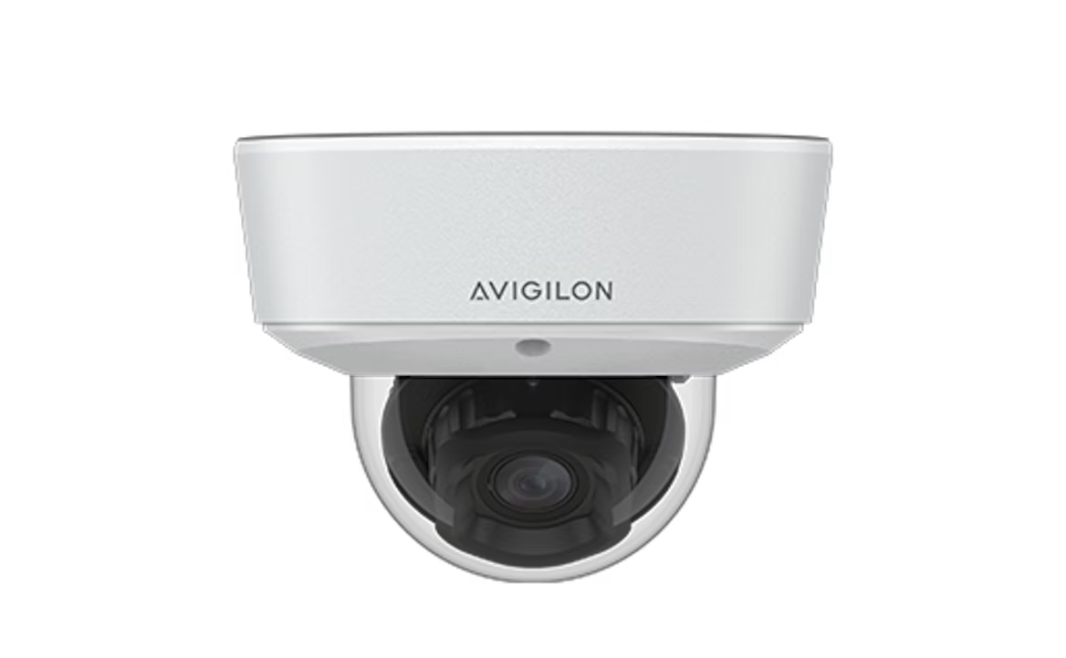 White Avigilon dome security camera, mounted on a ceiling.