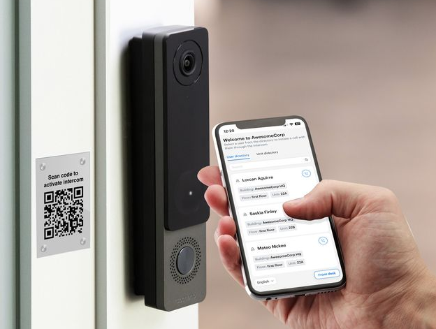 Person using smartphone to control a smart doorbell with a camera.