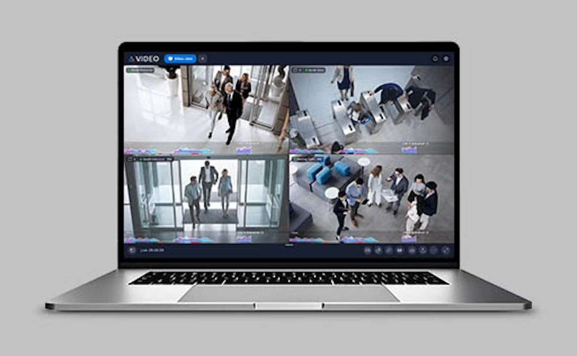 White security camera mounted on a wall bracket with a protective hood.