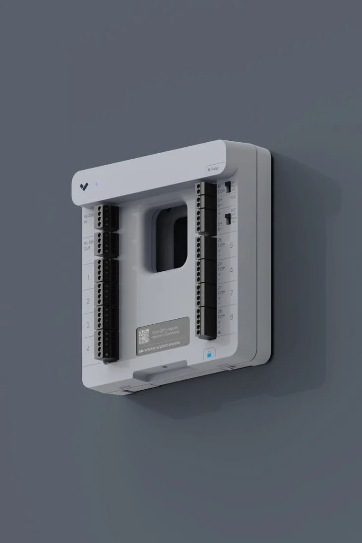 White rectangular electrical panel mounted on a gray wall. Black rails inside, small square label.