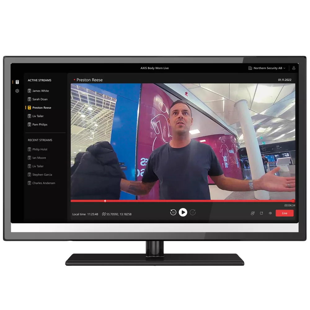 Man on TV screen with arms open in a public space, video interface, black screen border, and menu.