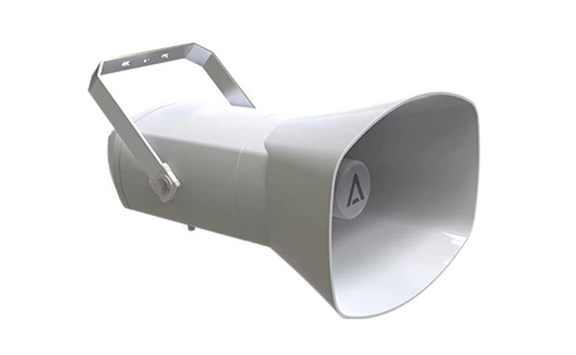 White security camera mounted on a wall bracket with a protective hood.