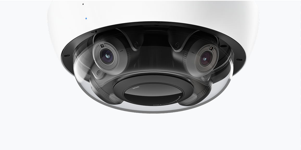 White dome security camera with multiple lenses.