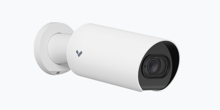 White security camera mounted on a wall.