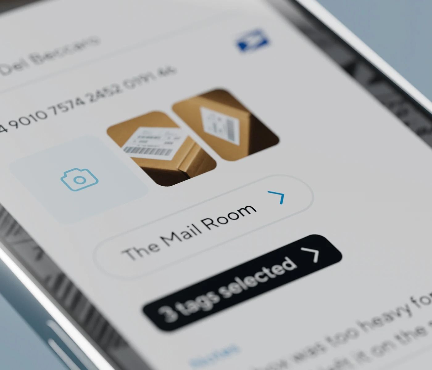 White security camera mounted on a wall bracket with a protective hood.