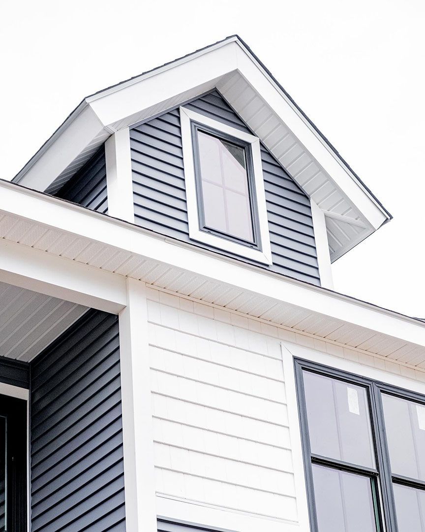 A house with a roof that has a window on it