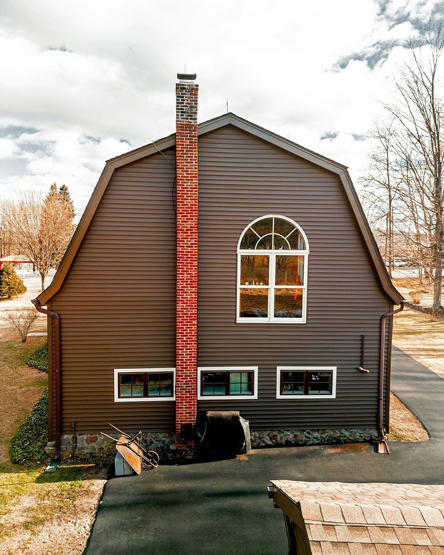A house with a wooden door and a light on the side