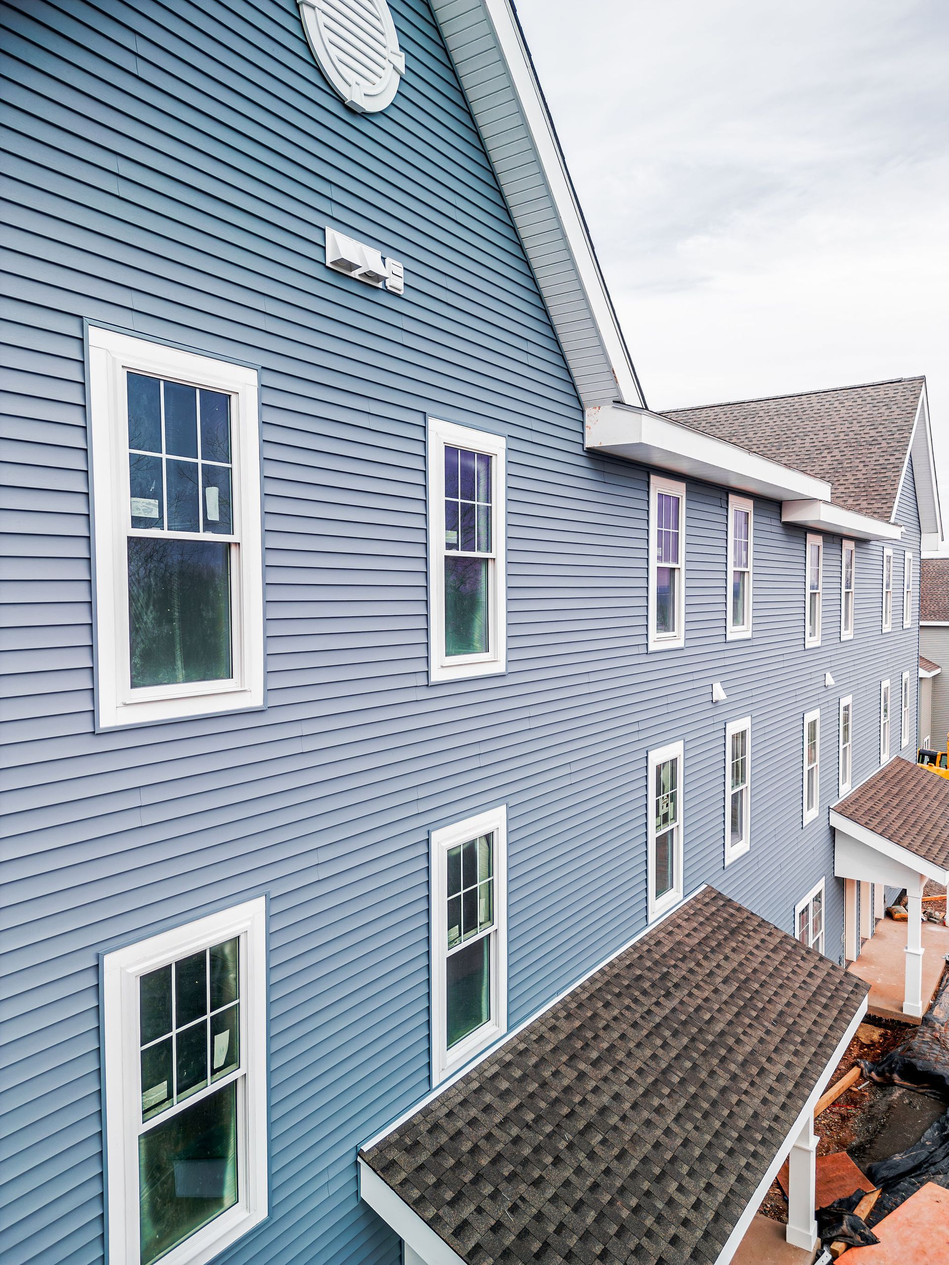 Blue building with white-framed windows. Angled perspective.