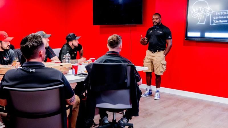 A man is giving a presentation to a group of people in a conference room.