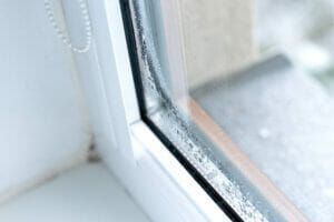 A close up of a window with condensation on it.