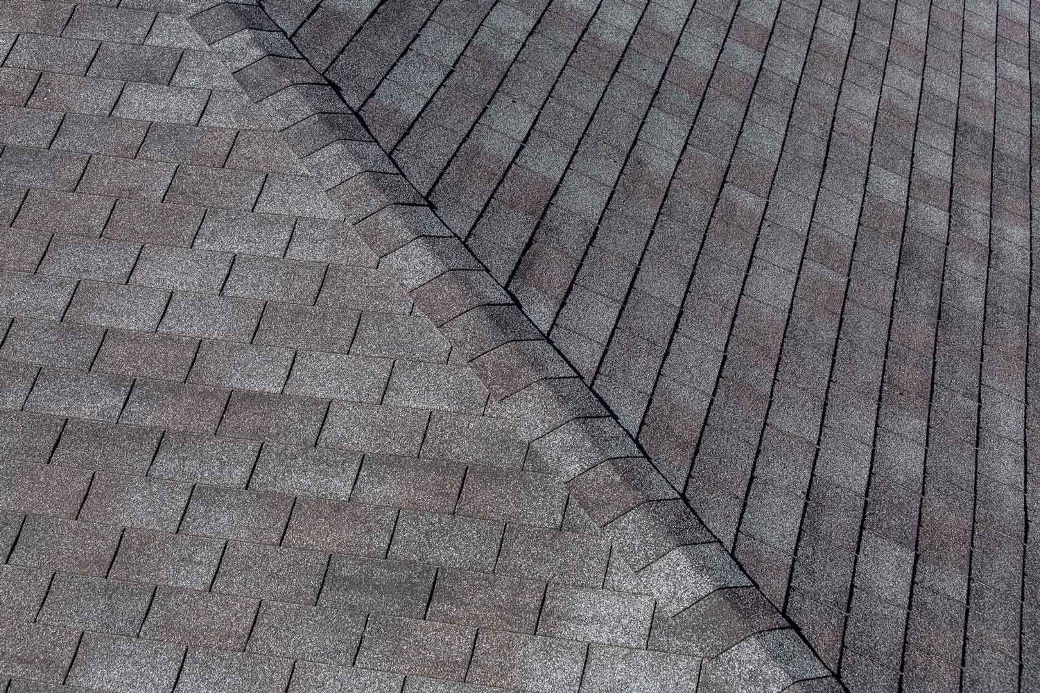 A close up of a roof before and after being cleaned.