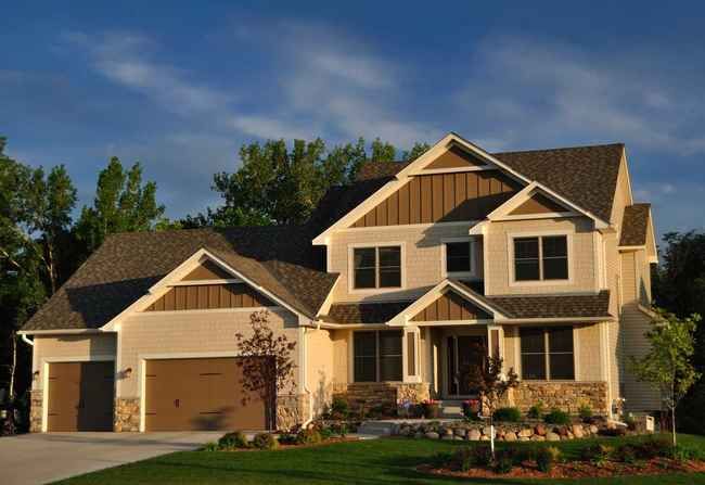 A large house with a lot of windows and a garage