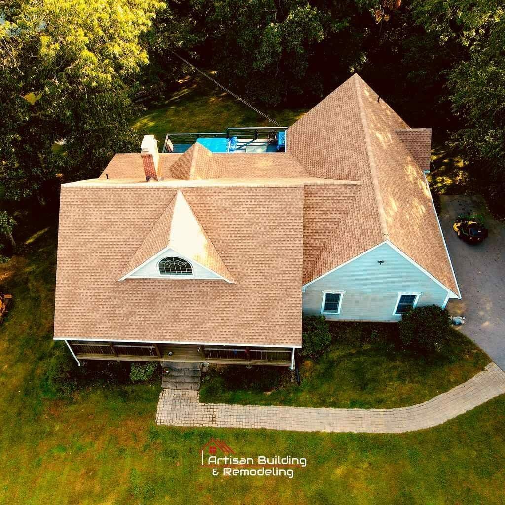 An aerial view of a house with a brown roof